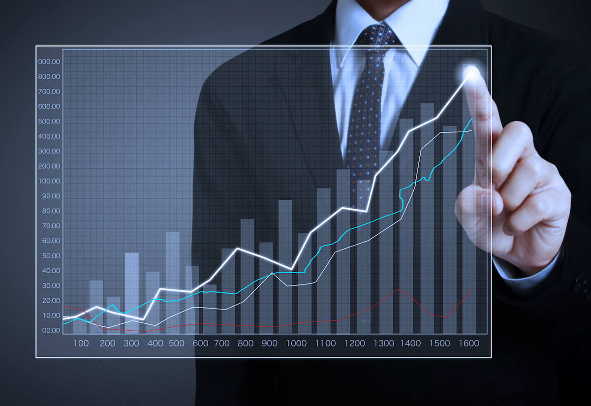 businessman with financial symbols coming from hand